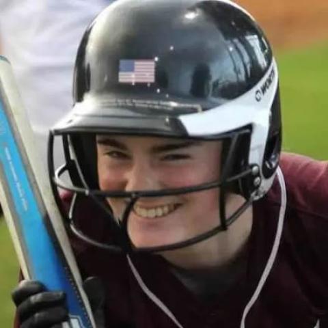 Hannah smiling with softball bat